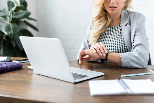 Business owner at a laptop planning the next steps for her company